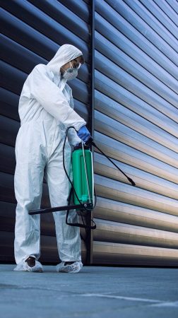 person-in-white-chemical-protection-suit-doing-disinfection-of-public-areas-to-stop-spreading-highly-contagious-corona-virus